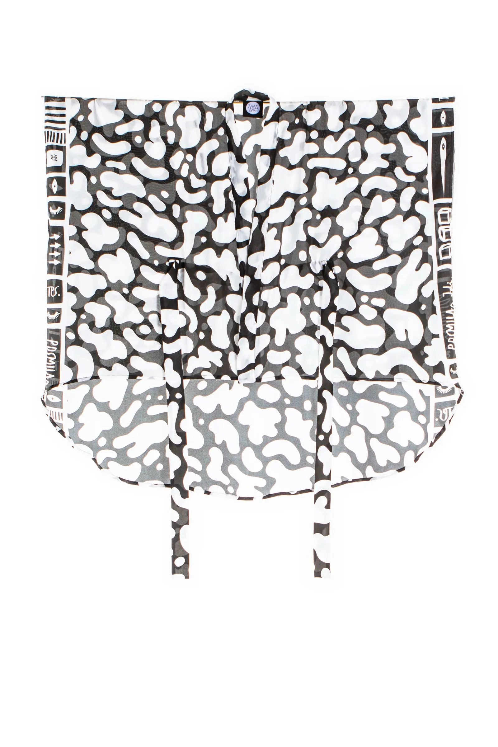 The short Blob kimono from the front, with white organic shapes against black, ties and a narrow geometric border along the edges.