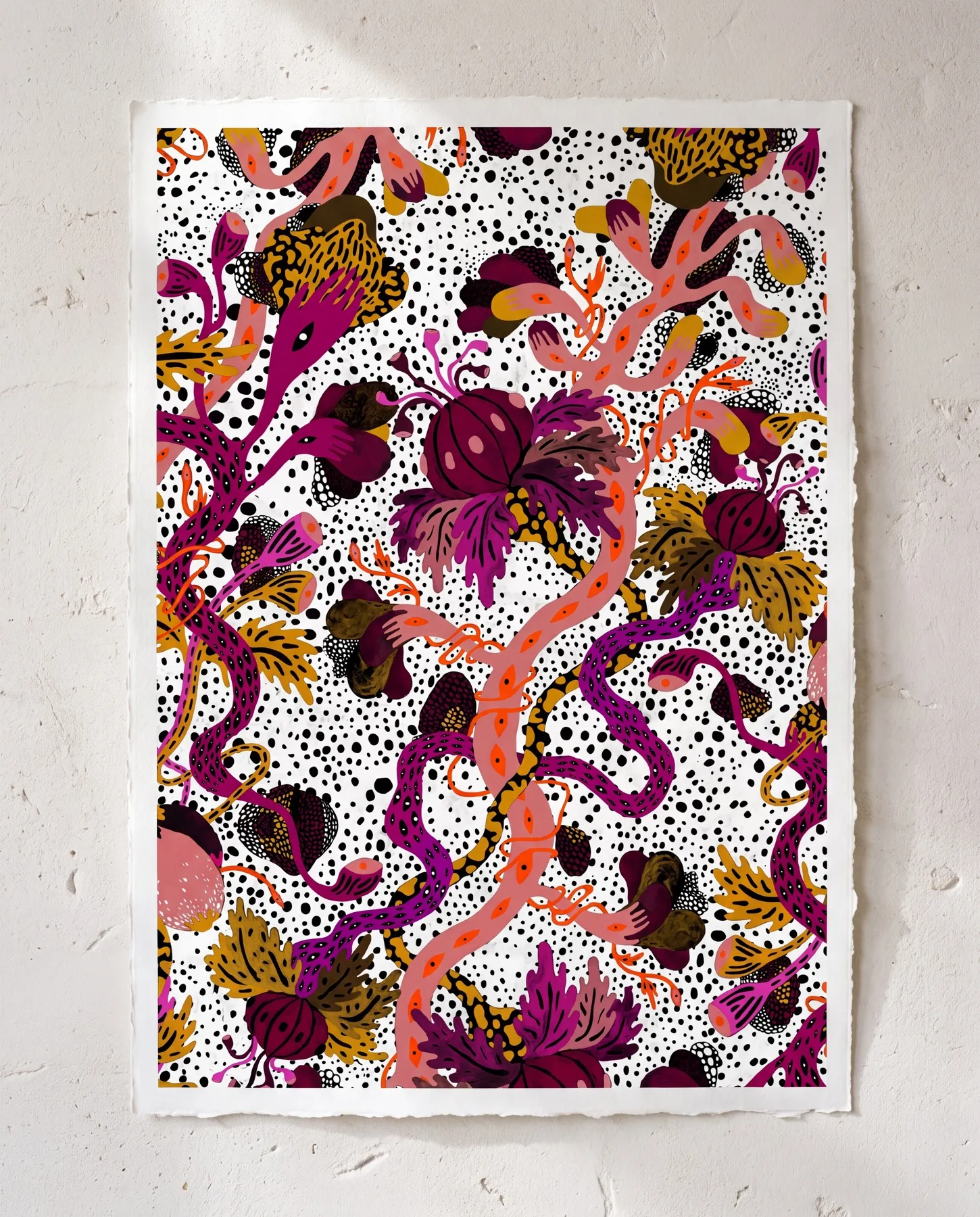 A visualisation presents the pattern as a sheet with an uneven cut edge mounted on a white plaster wall, featuring magenta flowers, ochre foliage and coral-pink snake-like forms.