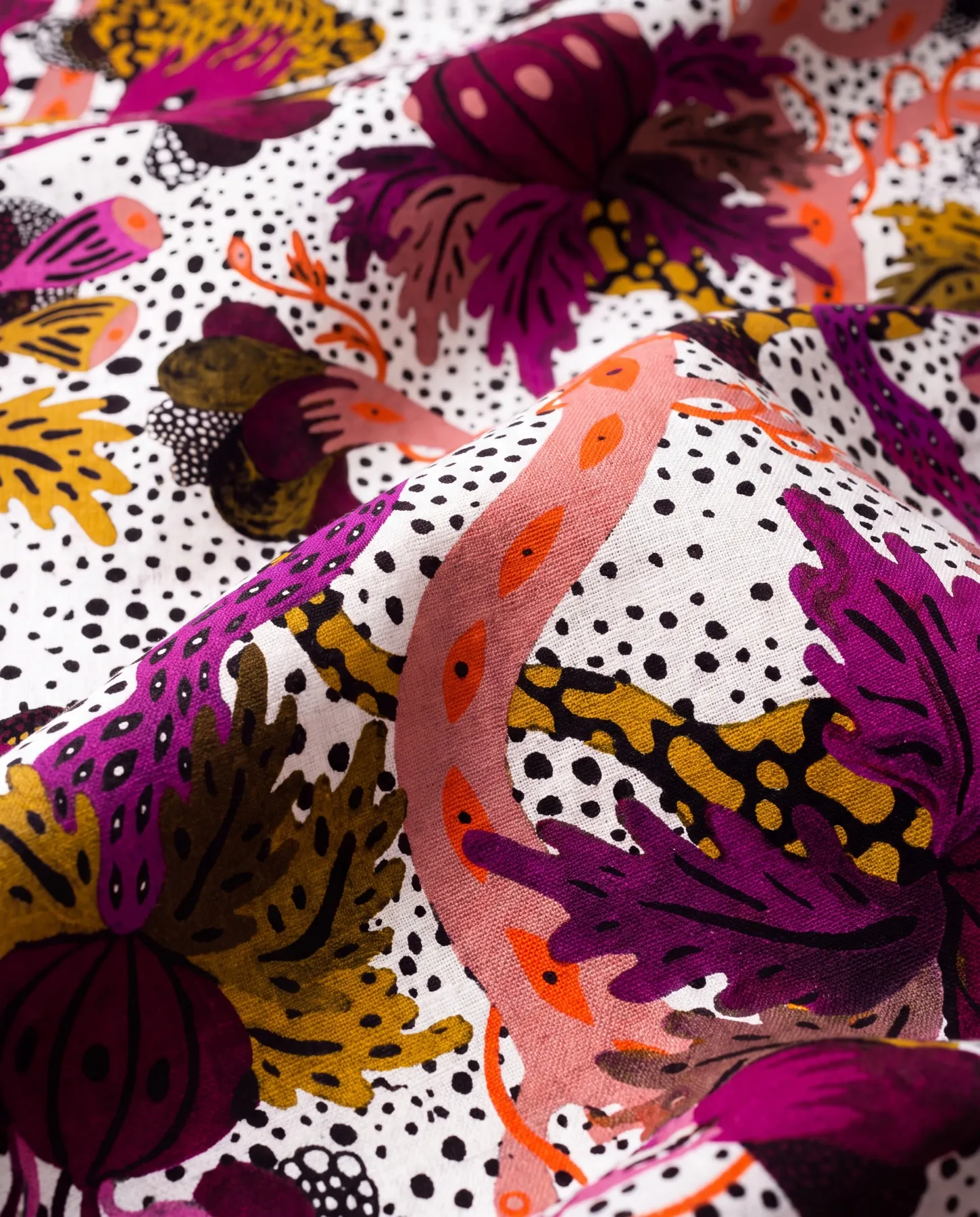 A visualisation presents a close-up of the fabric in soft folds, with magenta and plum-coloured forms, ochre foliage and a coral-pink band.